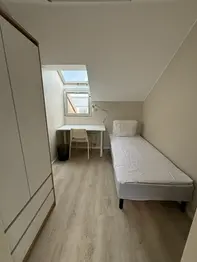 Student dorm room with bed