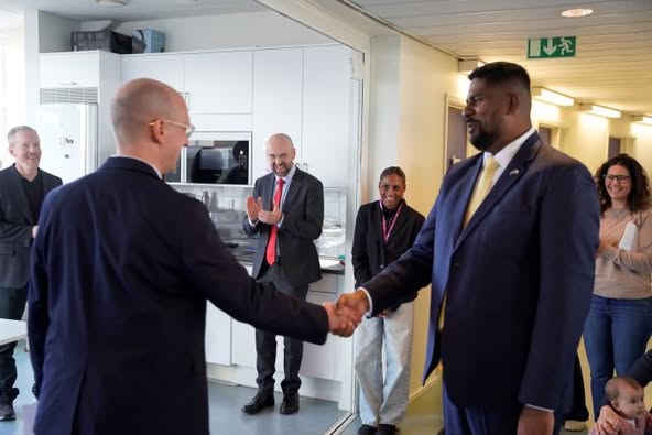 Two men wearing suits shaking hands